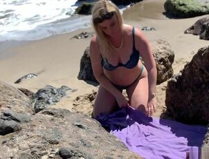 Sensual platinum-blonde sunbathing bare on the beach